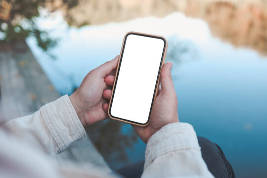 Phone with isolated screen on the background of the river