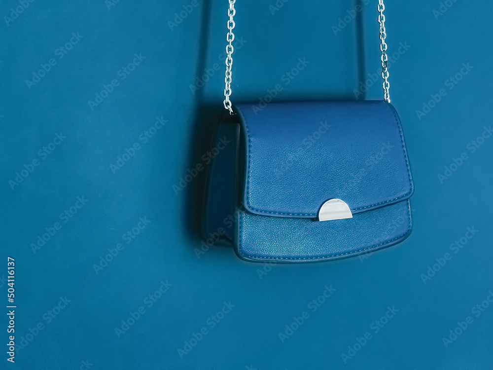 Wall mural blue fashionable leather purse with silver details as designer bag and stylish accessory, female fas