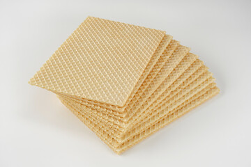 Close up of stack of wafer or waffle sheets on a white background. Shallow depth of field