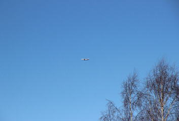 Fototapeta na wymiar Silhouette of a passenger plane against a clear sky