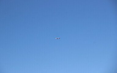 Silhouette of a passenger plane against a clear sky