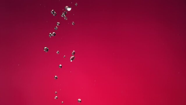 Flying of Pomegranate in Fuchsia Background in Slow Motion