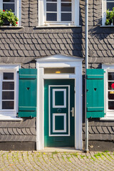Naklejka premium Historic old house with green wooden shutters in Essen-Werden, Germany