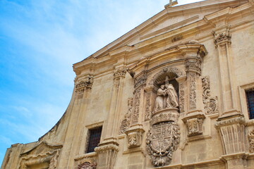 Main facade of the Church of Santo Domingo in Murcia, in baroque style with sculpture