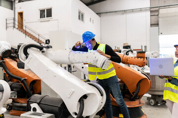 engineer employee checking a robotic arm