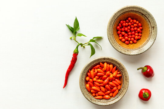 Top view of various red ripe chili peppers different cultivar (red cherry chili, pequin chili, chiltepin chili, cayenne long slim ).