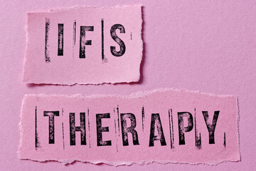 IFS therapy written on pink paper notes. Internal Family Systems psychotherapy treatment concept.