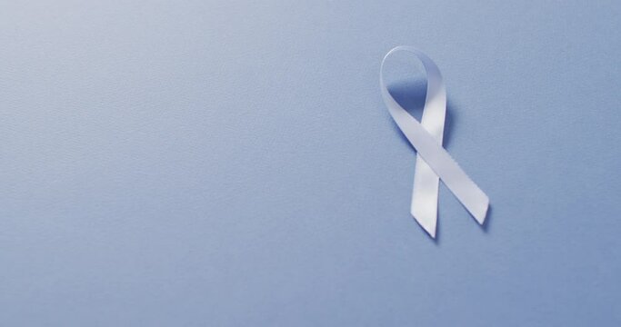 Video of pale blue prostate cancer ribbon on blue background