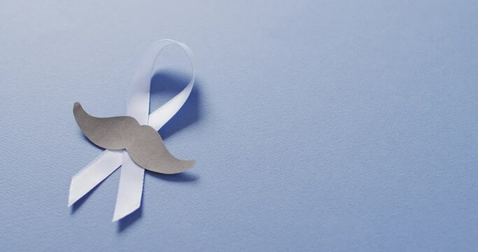 Video of paper moustache and pale blue prostate cancer ribbon on pale blue background