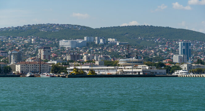 View of Novorossiysk Embankment of Admiral Serebryakov and the building of Marine Station from side of Western mole. Novorossiysk, Russia - September 15, 2021