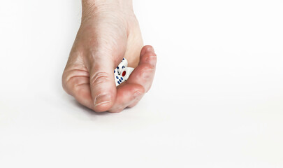 Poker dice in hand on white background.