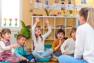 Active preschool Children Interacting with their Teacher. Teacher-child relationships – Early Learning.  Healthy Learning Environment - obrazy, fototapety, plakaty