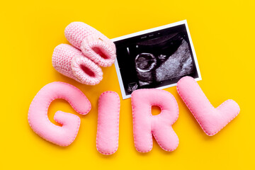 Baby girl. Prenatal ultrasound screening of unborn baby with letters girl