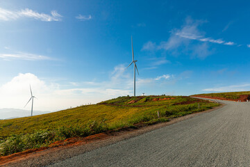 Renewable energy wind turbines windmill isolated on the beautiful blue sky and on the tea fields in Da Lat city, Lam Dong, Viet Nam