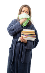 A woman in a bathrobe holds a lot of books. sneezes and coughs into a handkerchief, relaxes with an interesting book. Self isolation. coronavirus, flu, epidemic. isolated.