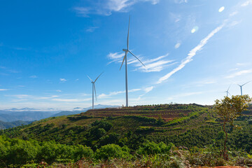 Renewable energy wind turbines windmill isolated on the beautiful blue sky and on the tea fields in Da Lat city, Lam Dong, Viet Nam