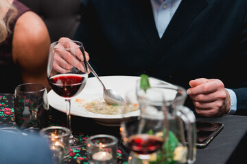 Man eating mushroom cream soup in a restaurant