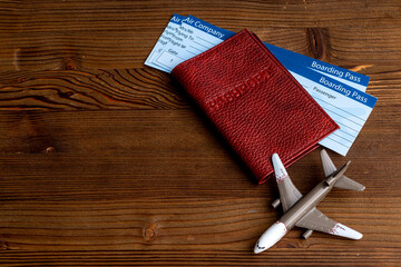 Ait tickets in passport and airplane. Immigration or tourism concept