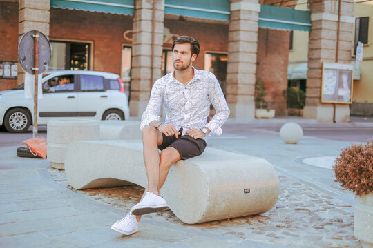 Handsome Italian Dark-haired Boy Walks Downtown In Bermuda