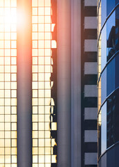 Abstract background of sunlight reflection on surface of high office buildings in the city at morning time