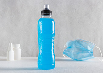 bottle of isotonic energy drink on gray background