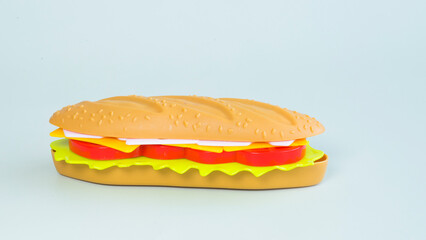 Toy sandwich on a plain background