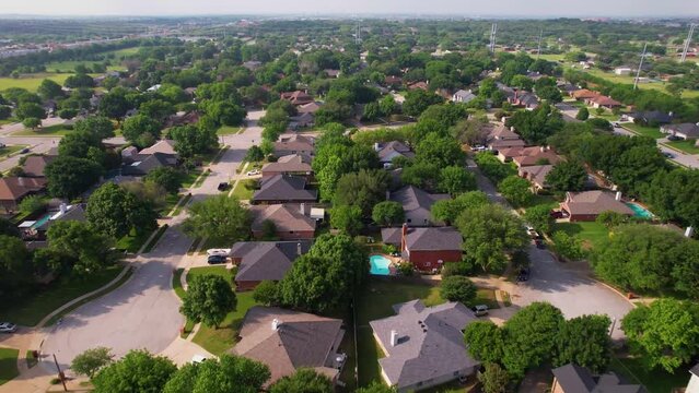 Aerial footage of a neighborhood in Keller Texas south of the KYA fields. Drone is flying south.