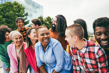 Young diverse people having fun outdoor laughing together - Focus on african girl face