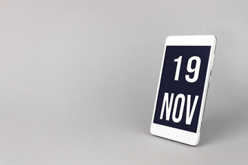 November 19th. Day 19 of month, Calendar date. Smartphone with calendar day, calendar display on your smartphone. Autumn month, day of the year concept.