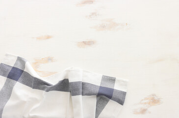 Naklejka premium top view of vintage tablecloth with over white wooden background