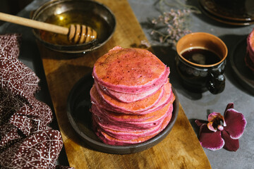 Pink beet pancakes poured honey