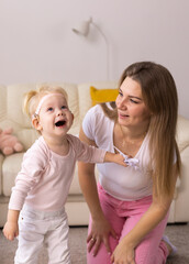 Cochlear implant on the child girl head and playing with mother Hearing aid and deafness and innovative health technology concept