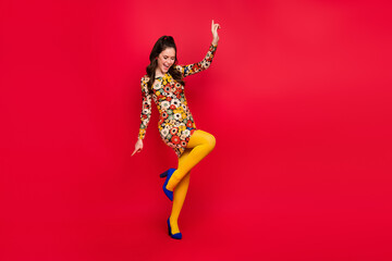 Full length body size view of attractive carefree cheerful girl dancing having fun isolated over vivid red color background