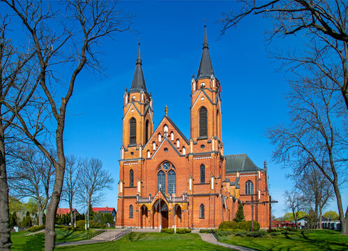 The photos show a general view of the Catholic Church of the Nativity of the Blessed Virgin Mary in the village of Rajgród in Podlasie, Poland, built in the neo-Gothic style in 1905-1912.
