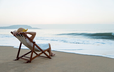 Fototapeta na wymiar Young woman relaxing on the beach.