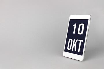 October 10th. Day 10 of month, Calendar date. Smartphone with calendar day, calendar display on your smartphone. Autumn month, day of the year concept.