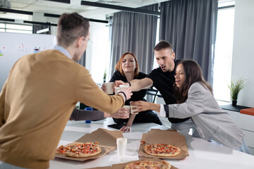 Colleagues celebrate the successful start of a business project in the office