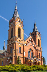 Obraz premium The photos show a general view of the Catholic Church of the Nativity of the Blessed Virgin Mary in the village of Rajgród in Podlasie, Poland, built in the neo-Gothic style in 1905-1912.