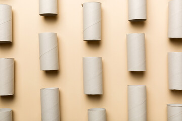 Empty toilet paper roll on colored background. Recyclable paper tube with metal plug end made of kraft paper or cardboard