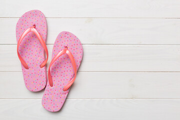 Flat lay composition with flip flops and seashell on colored background. Space for text top view