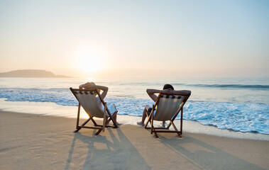 Fototapeta na wymiar Couple sunbathing on a beach chair.