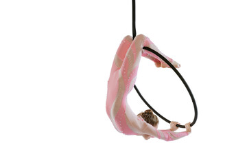 Portrait of young sportive girl, air gymnast performing on hoop isolated over white studio...