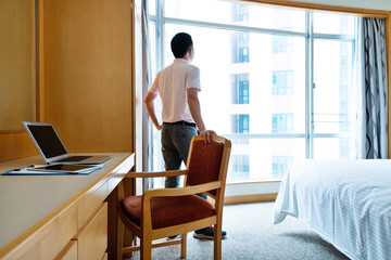 Man standing in front of the window