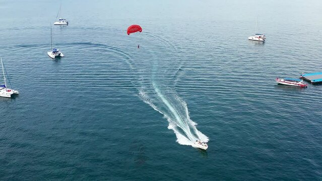 Paragliding over Coral island, koh He, beach and boats in Phuket province, Thailand
