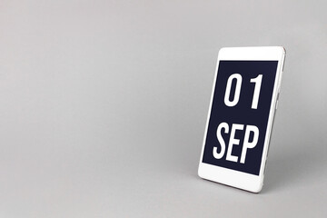 September 1st . Day 1 of month, Calendar date. Smartphone with calendar day, calendar display on your smartphone. Autumn month, day of the year concept.