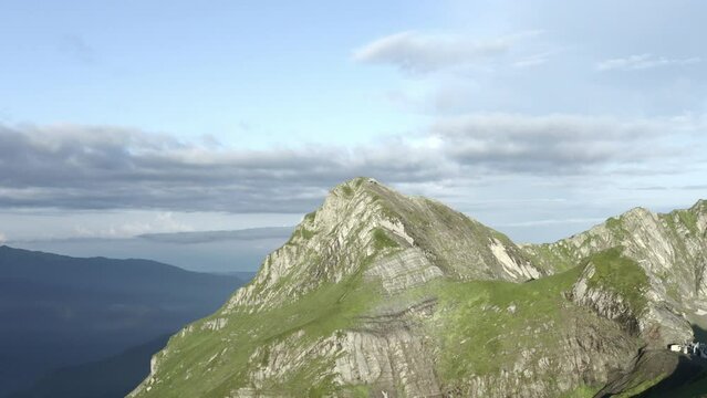 Shooting from drone gorgeous natural mountain cliff with gazex summit by sunny landscape clear blue sky. Aerial view adorable rocky peak atmosphere cloudscape cinematic forecast weather. 4k video