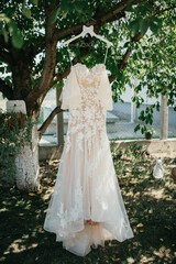 Beautiful wedding dress on hangers.