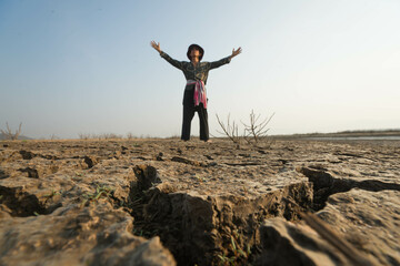 man sadness from dry land. The concept for climate change from global warming. Photograph close up...