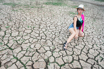 woman portrait in dryland with drought ground texture. concept climate changed.