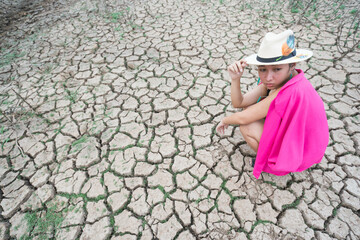 woman portrait in dryland with drought ground texture. concept climate changed.